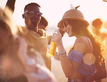 People dancing to live music and drinking bottled beer