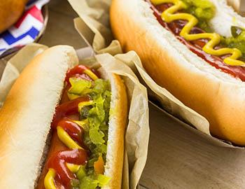 Hot dogs with ketchup, mustard and onion