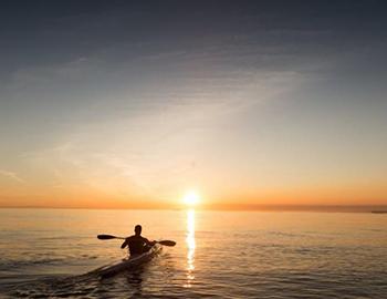 Kayaking on the water at sunset