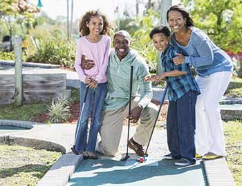 Family playing a game of mini golf