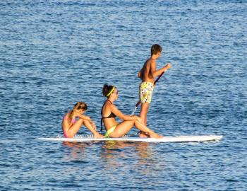 Family paddling on SUPs