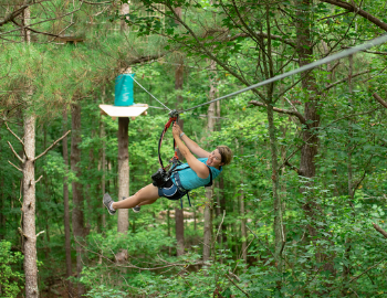 Woman zip lining through the sky