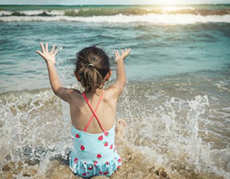 Young girl playing in the tide at Oak Island, NC