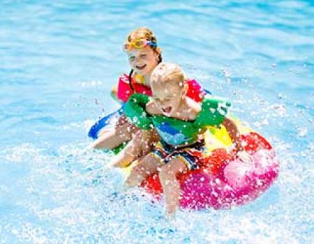 Kids playing in a pool at a vacation rental in Oak Island