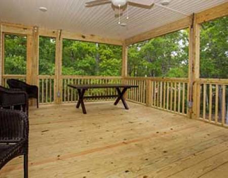 The covered porch of an Oak Island vacation rental by Rudd