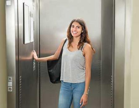 Girl standing in front of an elevator in her vacation rental home