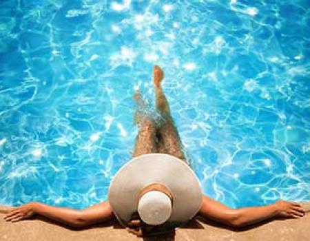 Woman soaking in a private pool at a vacation rental home