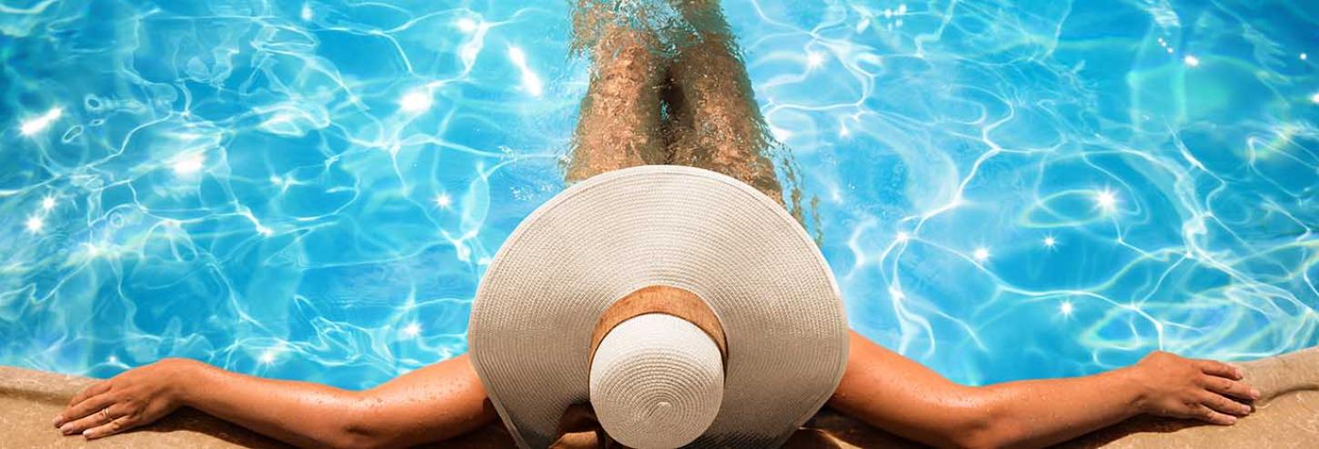 Woman in a sun hat enjoying a private pool