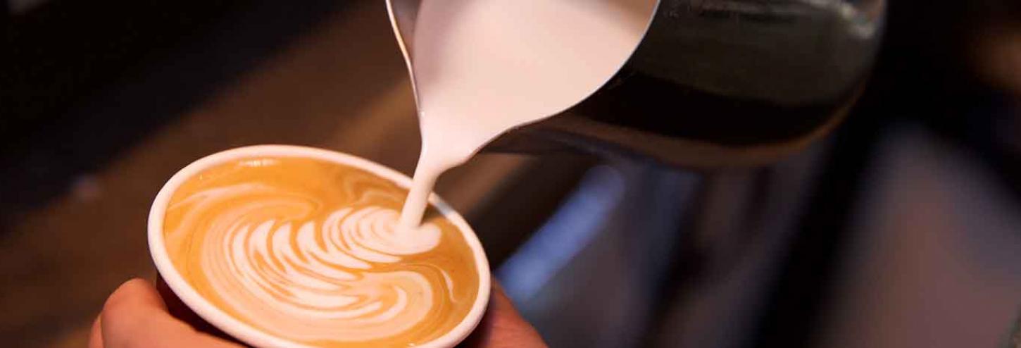 Barista pouring a latte