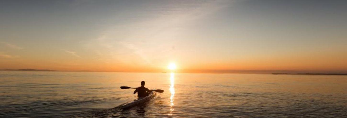 Kayaker on the water at sunset