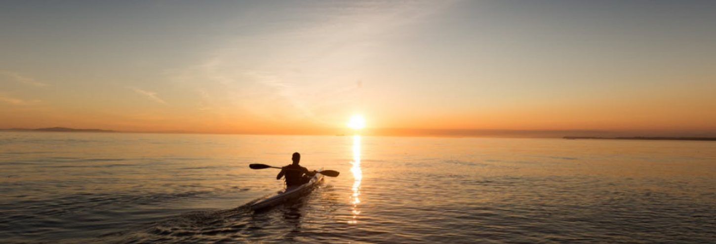 Kayaker on the water during a beautiful sunset