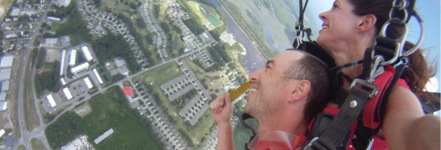 Couple skydiving from a plane in North Carolina