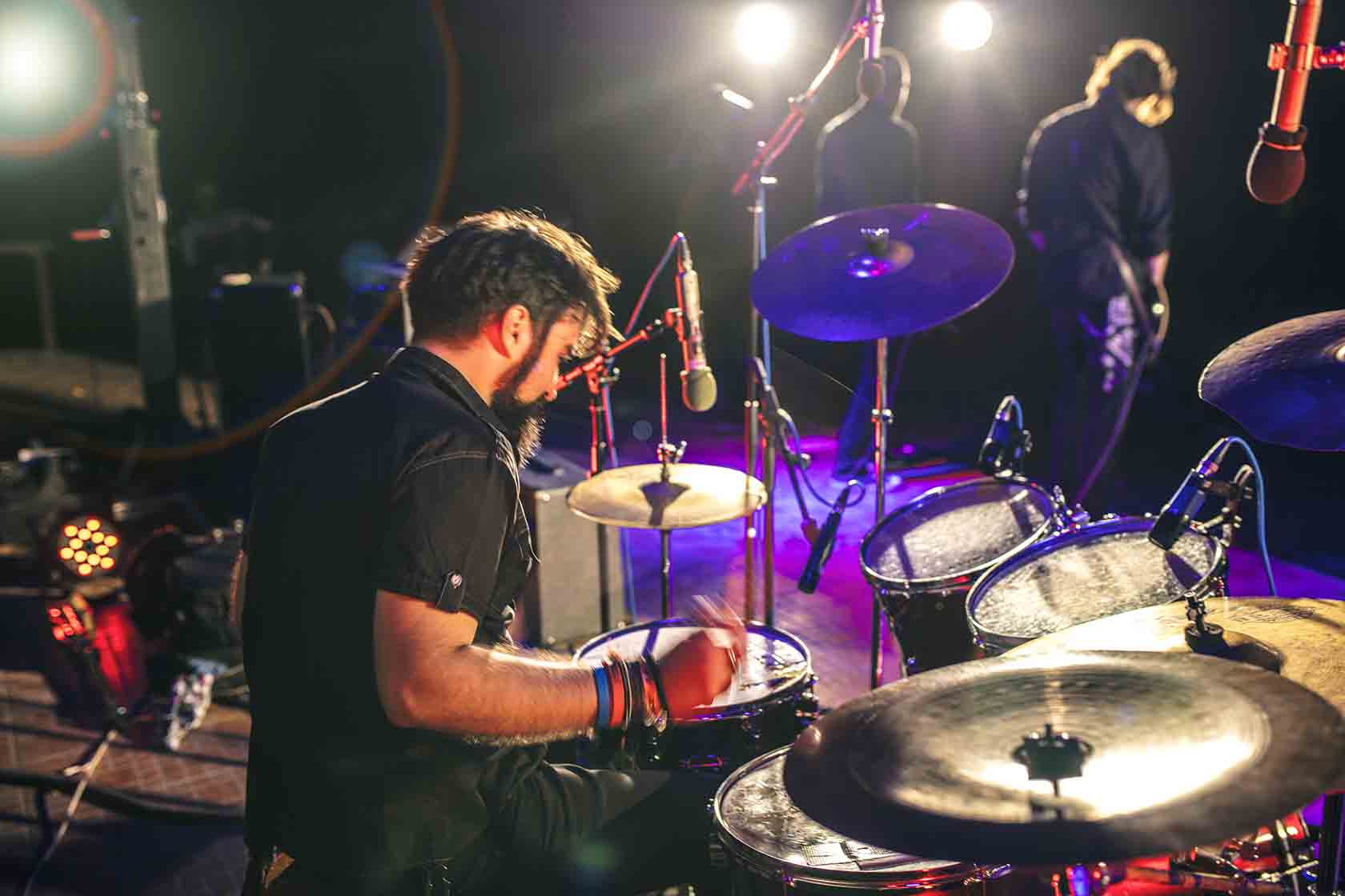 Drummer in a band performing at a bar