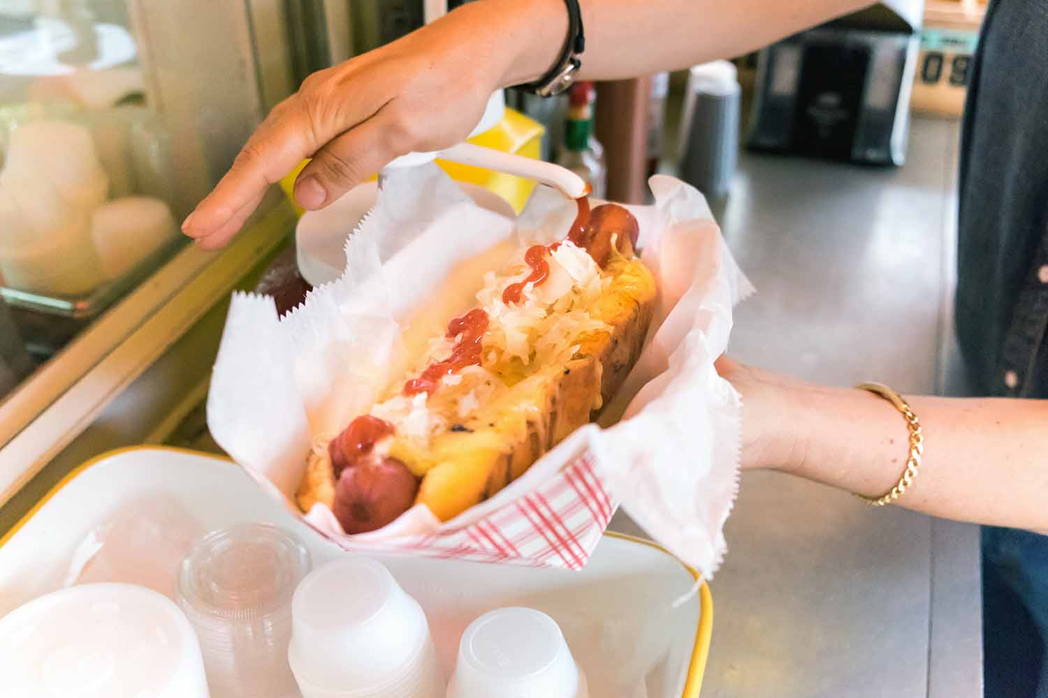 Chef preparing a loaded hot dog