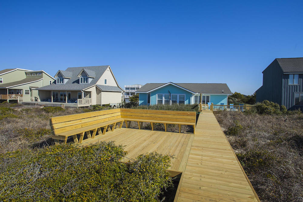 Sitting area along beach boardwalk at a Caswell Beach vacation rental