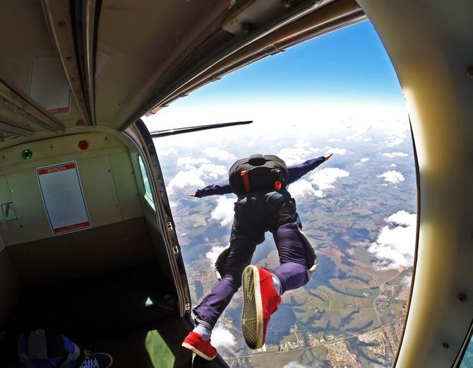 A man jumps out of a plane to skydive