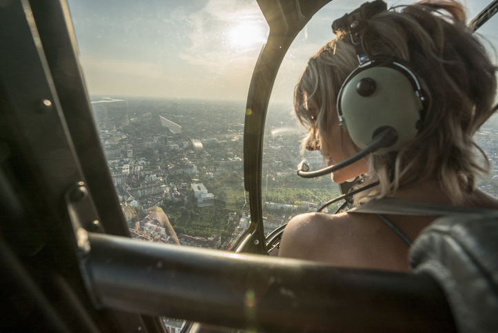 A woman looks out during a helicopter tour