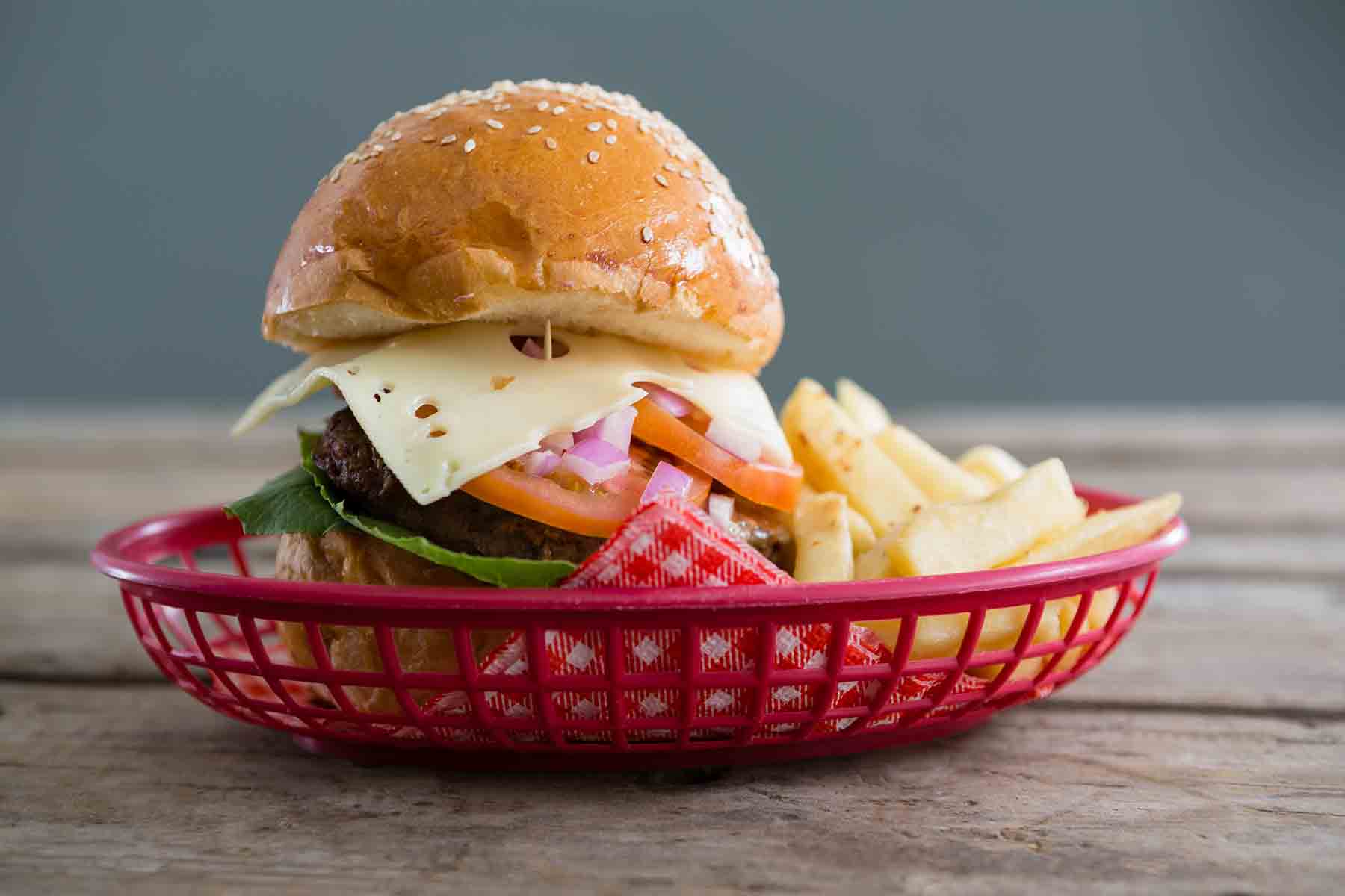 Burger basket on a picnic table outside