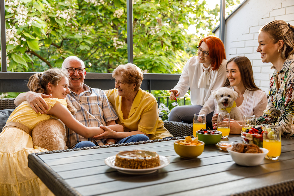 multi-generational family sitting on porch