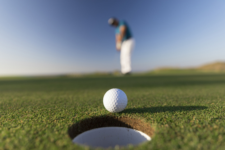 oak island golf club, up close image of golfer putting on a green