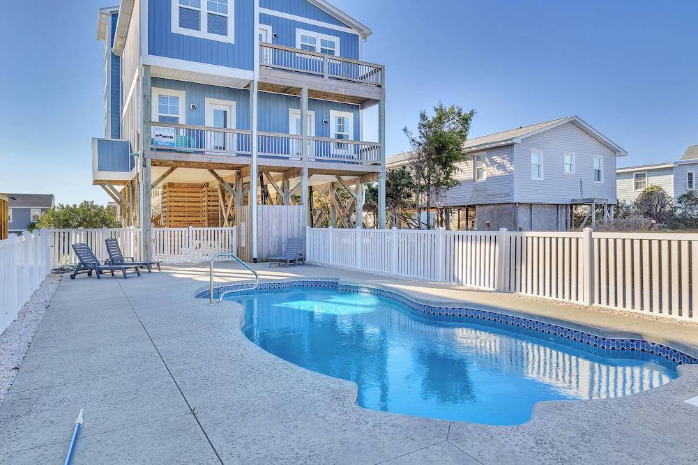 Large blue beach house with view of fenced in private pool