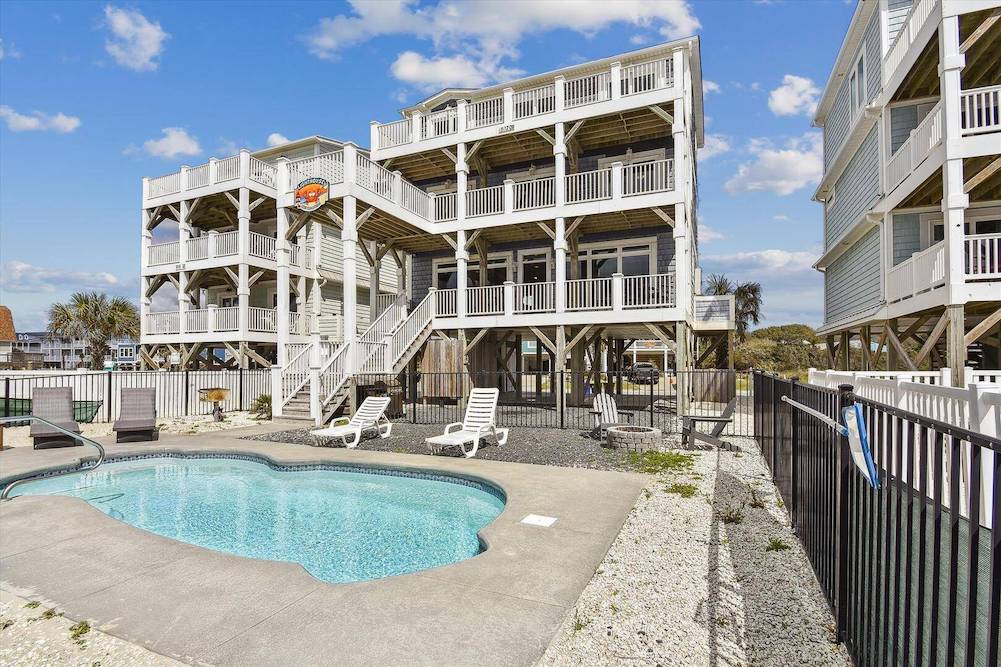 tall beach house in Oak Island, NC featuring backyard private in-ground pool